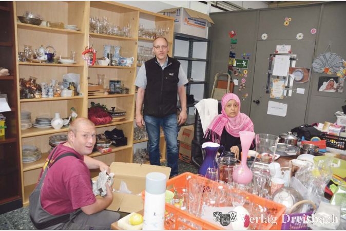 Jede Kiste ein Überraschungspaket – mit dem richtigen Blick suchen die im Sozialkaufhaus Tätigen nach gut erhaltenen Gegenständen, die sich zum Wiederverkauf eignen. Jörg Jäger und Zahra Mohamed (ehrenamtliche Helferin) packen gerne mit an. Unterstützung leistet auch Diplom-Pädagoge Marcus Sünder (Mitte).
(Foto: R. Dörhöfer)