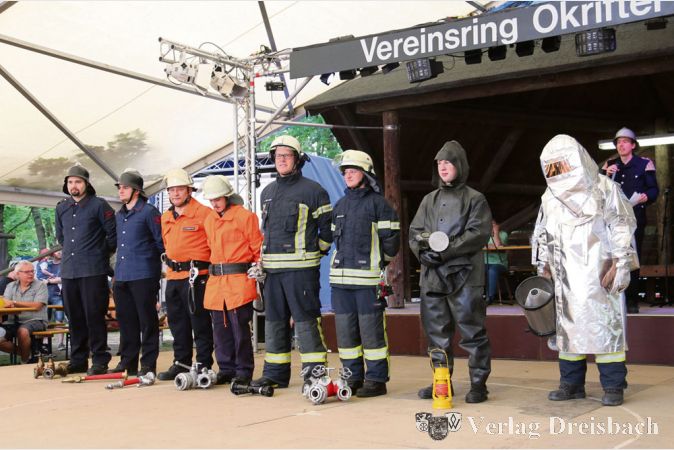 Die Freiwillige Feuerwehr Okriftel hatte f&uuml;r den Vereinsvormittag beim diesj&auml;hrigen W&auml;ldchesfest in ihrem Fundus gesucht und dabei Uniformen und Ausr&uuml;stungsgegenst&auml;nde aus der Zeit ihres 112-j&auml;hrigen Bestehens gefunden, die Vorsitzender Andreas Weber dem Publikum vorstellte.
(Fotos: A. Kreusch)