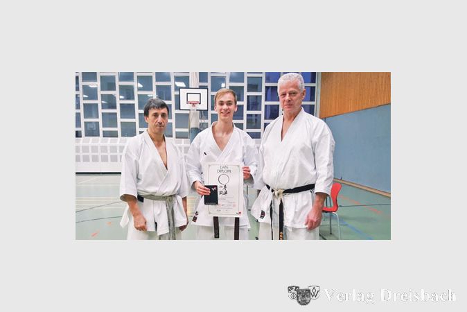 Jan Clemens nach seiner erfolgreichen Danpr&uuml;fung zusammen mit den beiden Pr&uuml;fern Bundestrainer Eftimios Karamitsos (l.) und Gunar Weichert (r.).
(Foto: privat)