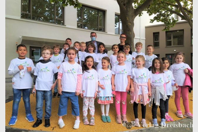 Die Kinder der Klasse 1d mit Bürgermeister Christian Seitz und Klassenlehrerin Elisabeth Oste vor dem neuen Erweiterungsbau der Lindenschule.